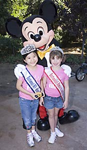 Sarah Wang & Hannah Riekhof pose with Mickey Mouse at Disneyland